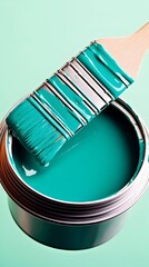 Teal paintbrush dipping paint can, studio shot