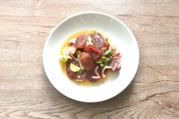 spicy and sour sweet slice Chinese pork sausage with vegetable salad on plate  