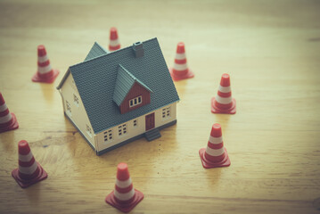 House around by emergency traffic cone. Mortgage loan overdue payment, foreclosure, expense...