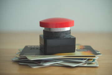 Close up red stop emergency button on many credit cards. Past due payment or least minimum for...