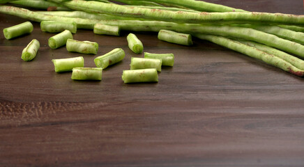 Fresh organic or French beans green peas on wooden background.Healthy food concept.