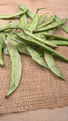 Pile of green beans over wooden background, Healthy food concept 