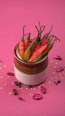 Fresh long Indian green and red chillies on beautiful background. Organic Indian spices for hot and spicy cuisine. 