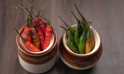 Fresh long Indian green and red chillies on beautiful background. Organic Indian spices for hot and spicy cuisine. 
