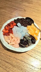 Anmitsu dessert of agar jellies, strawberries, grapes, lychees, red beans, oranges