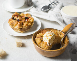 Overhead view of homemade bread pudding with vanilla ice cream, top view of fresh bread pudding with cream
