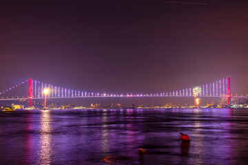 Night view of the Bosphorus Bridge (15 July Martyrs Bridge) in Istanbul with colorful lights and...