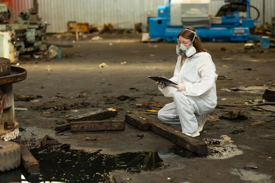 Caucasian woman worker with safety protective face mask in factory. Officials from the Department of Hazardous substances control bureau is investigating the leak of hazardous chemical in industry