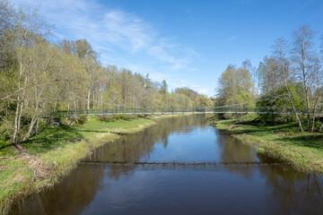 Salaca river with pedesrtian bridge. Latvia