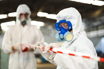 red barrier cross tape : No trespassing. man workers Officials from the Department of Hazardous...