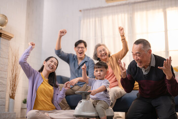 Family members enjoying a joyful moment together in a cozy living room while celebrating a special occasion