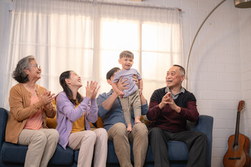 Family celebrating a young child's achievements in a cozy living room during daytime