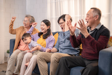 Family gathers on couch, celebrating a joyful moment together in cozy living room during afternoon