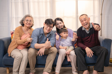 Family members expressing joy while posing together on a cozy sofa in a bright living room during a...