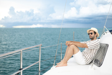 A man is relaxing on a yacht in the middle of the sea. A luxurious lifestyle.