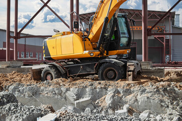 Fototapeta premium Construction equipment actively working on a building site during the day