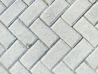 Gray Brick Paving Pattern on Concrete Surface Suitable for Outdoor Walkways and Landscaping