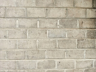 Gray Brick Wall with Weathered Texture Suitable for Background or Construction Design