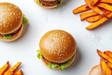 Overhead view of plant-based burger served with sweet potato fries on a white background