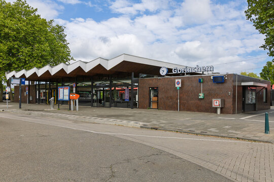 The modern Gorinchem railway station in the Netherlands features a distinctive zigzag roofline, set against a bright, cloudy sky. Gorinchem, Netherlands, 22 May 2025.
