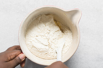 overhead view of vanilla sugar cookie dough being mixed in a bowl, top view of plain vanilla cookie dough being mixed, process of making sugar cookies