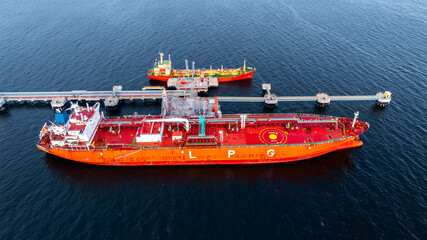 Aerial view LPG gas tanker ship at oil and gas terminal platform, Liquefied Petroleum Gas tanker ship industrial offshore oil gas terminal tanker ship LPG tanker ship loading arm loading and unloading