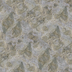A coarse gray stone surface with green and brown speckles, rugged texture and natural mineral depth.