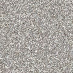 A coarse granite surface with speckled gray, beige, and black patterns, rugged natural texture and depth.