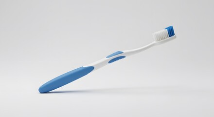 A modern blue and white toothbrush for daily oral care, isolated on a minimalist light grey background. Concept of dental health and personal hygiene.
