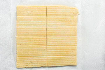 overhead view of stamped vanilla shortbread cookie dough on granite countertop, top view of cookie dough, process of making shortbread cookies