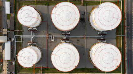 Aerial top view petrochemical plant oil refinery storage tank pipe line at night, Petroleum oil refinery industrial infrastructure oil storage tank, Oil refinery petrochemical industrial chemical.