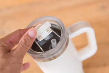 cap of White HANDLE TUMBLER on wood table 