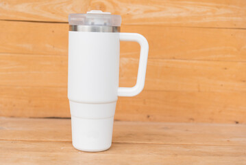 White HANDLE TUMBLER on wood table  
