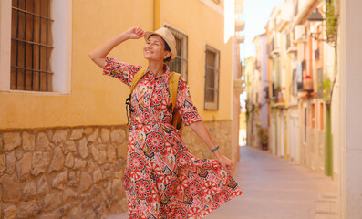 Woman strolls through colorful streets of Spanish coastal town