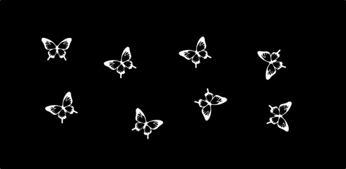 Eight white butterflies scattered across a black background in a minimalist and elegant arrangement