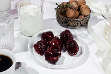 Nuts and dried fruits in pomegranate juice on a plate. Churchkhela. Georgian churchkhela in pomegranate juice