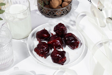 Nuts and dried fruits in pomegranate juice on a plate. Churchkhela. Georgian churchkhela in pomegranate juice