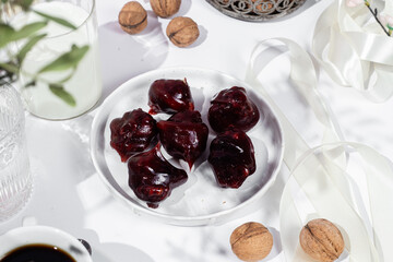 Nuts and dried fruits in pomegranate juice on a plate. Churchkhela. Georgian churchkhela in pomegranate juice