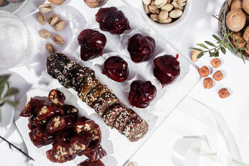 Nuts and dried fruits in pomegranate juice on a plate. Churchkhela. Georgian churchkhela in pomegranate juice