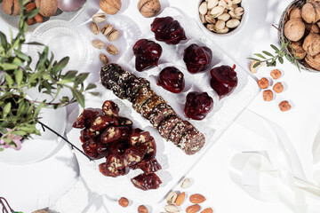 Nuts and dried fruits in pomegranate juice on a plate. Churchkhela. Georgian churchkhela in pomegranate juice