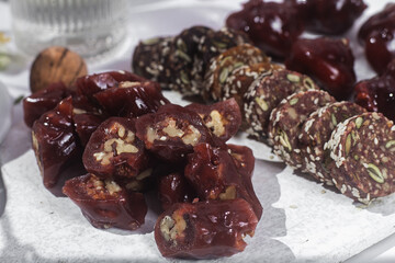 Nuts and dried fruits in pomegranate juice on a plate. Churchkhela. Georgian churchkhela in pomegranate juice