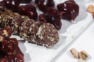Nuts and dried fruits in pomegranate juice on a plate. Churchkhela. Georgian churchkhela in pomegranate juice