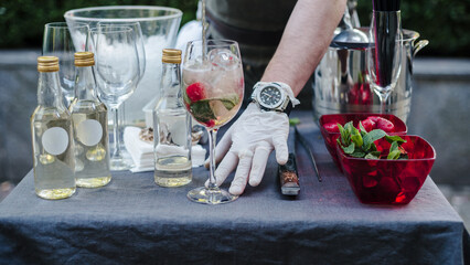 Bartender Preparing Summer Cocktail with Fresh Strawberries and Mint