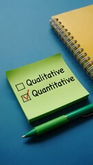 One person deciding between qualitative and quantitative written on sticky notes, illustrating analytical thinking

