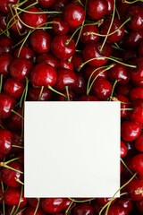 Cherries with a blank card for your text, top view