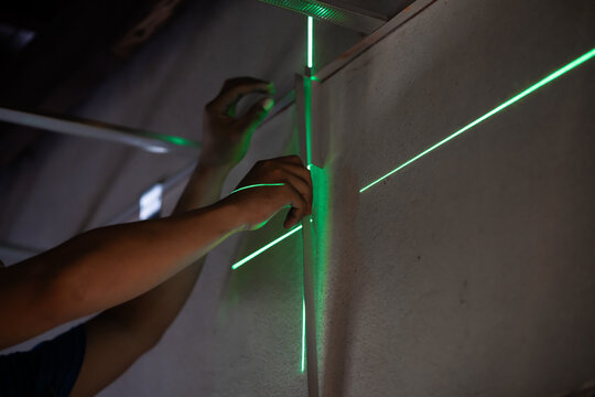 Precision measurement techniques using laser levels for accurate alignment workshop instructional guide indoor close-up diy skills