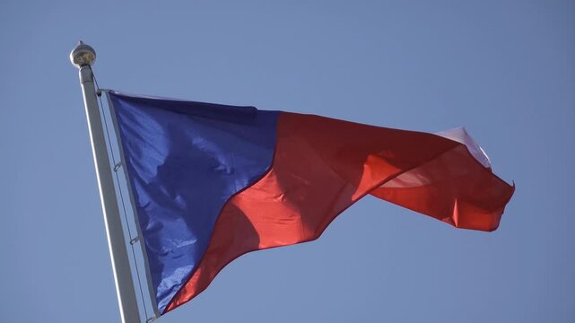 Czech flag waving in strong wind with blue sky
