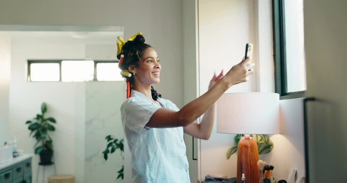 Woman, hairstyling and selfie with smile in bathroom for morning, makeover or routine in home. Girl, relax and excited with foam hair curling rods in apartment for haircare, getting ready and date