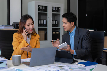 financial asian advisor showing plan of investment to clients in the consultancy office.