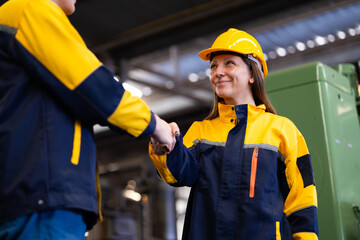 Unity and teamwork. People shaking hands on business agreement. Successful hand shaking after good deal. Professional Mechanical Engineer team Working at factory industrial facilities. Celebrate